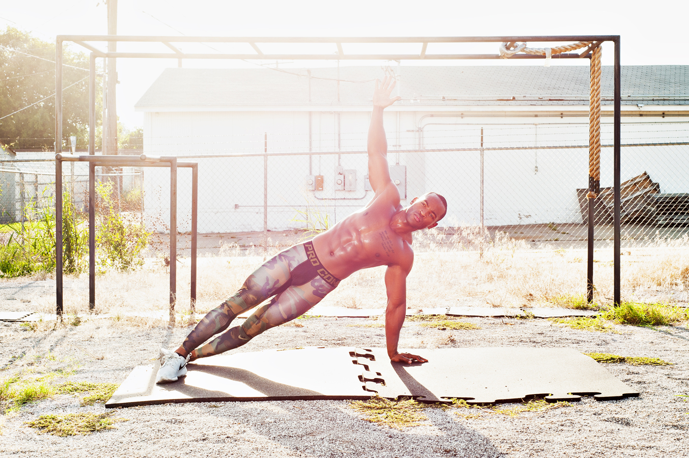 Fit black man doing side planks out outside shirtless. 

Kenneth M. Ruggiano is a photographer specializing in Sports and Fitness Photography based in Tulsa Oklahoma.