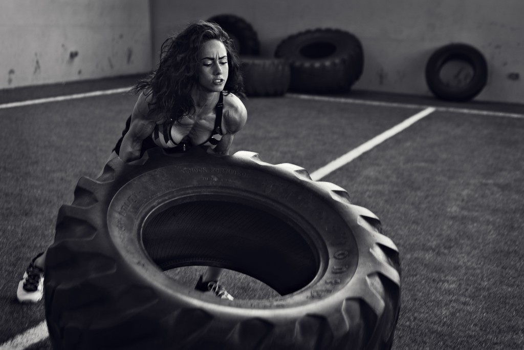 Fit women working out with a giant tire.  Kenneth M. Ruggiano is a Sports and Fitness Photographer based in Tulsa Oklahoma